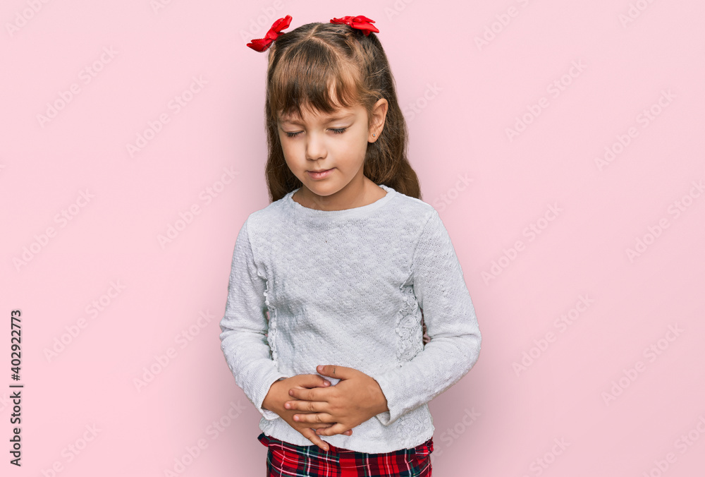 Little caucasian girl kid wearing casual clothes with hand on stomach because indigestion, painful illness feeling unwell. ache concept. Little caucasian girl kid wearing casual clothes with hand on stomach because indigestion, painful illness feeling unwell. ache concept.