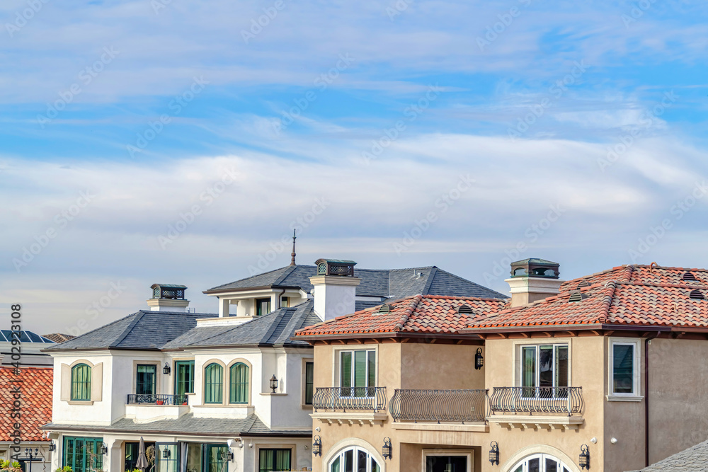 Homes with balconies in Huntington Beach California against clouds and blue sky