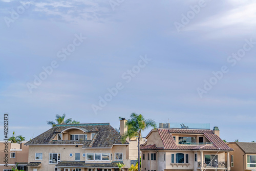 Houses with attics and balcony against cloudy sky in Huntington Beach California