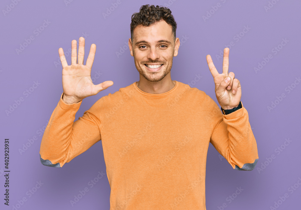 Young hispanic man wearing casual clothes showing and pointing up with fingers number seven while smiling confident and happy. Young hispanic man wearing casual clothes showing and pointing up with fingers number seven while smiling confident and happy.