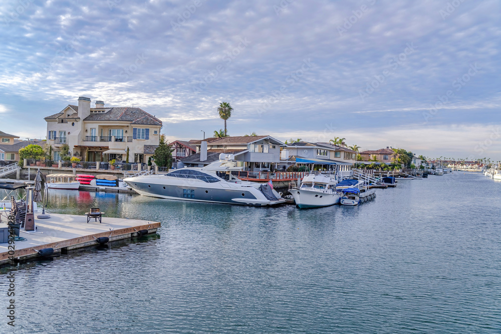 Leisure watercrafts on private docks of houses in Huntington Beach California