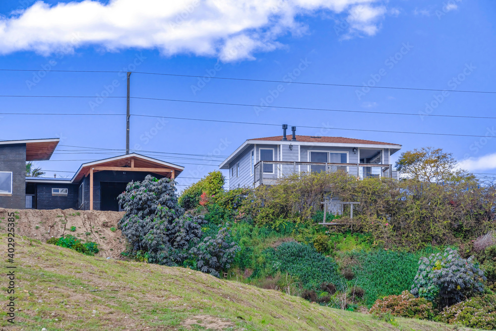 House and garage on a slope against blue sky background in San Diego California