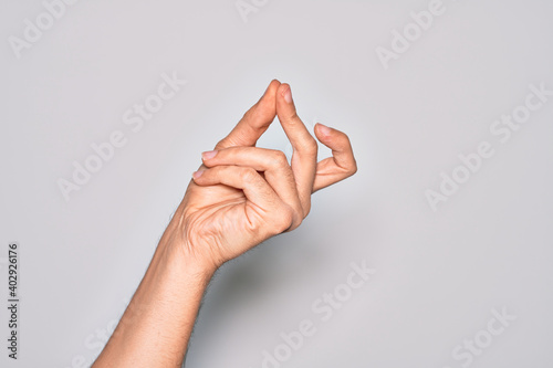 Quadro su tela Hand of caucasian young man showing fingers over isolated white background snapp
