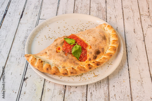 Photos Calzone pizza with tomato and basil