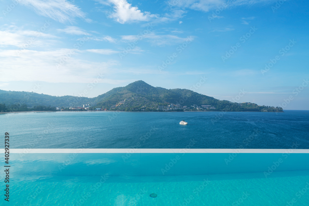 Swimming pool with stair on top of roof deck building looking at view tropical sea ,Luxury beach villa house with sea view swimming pool in modern design,Summer Vacation and travel background concept