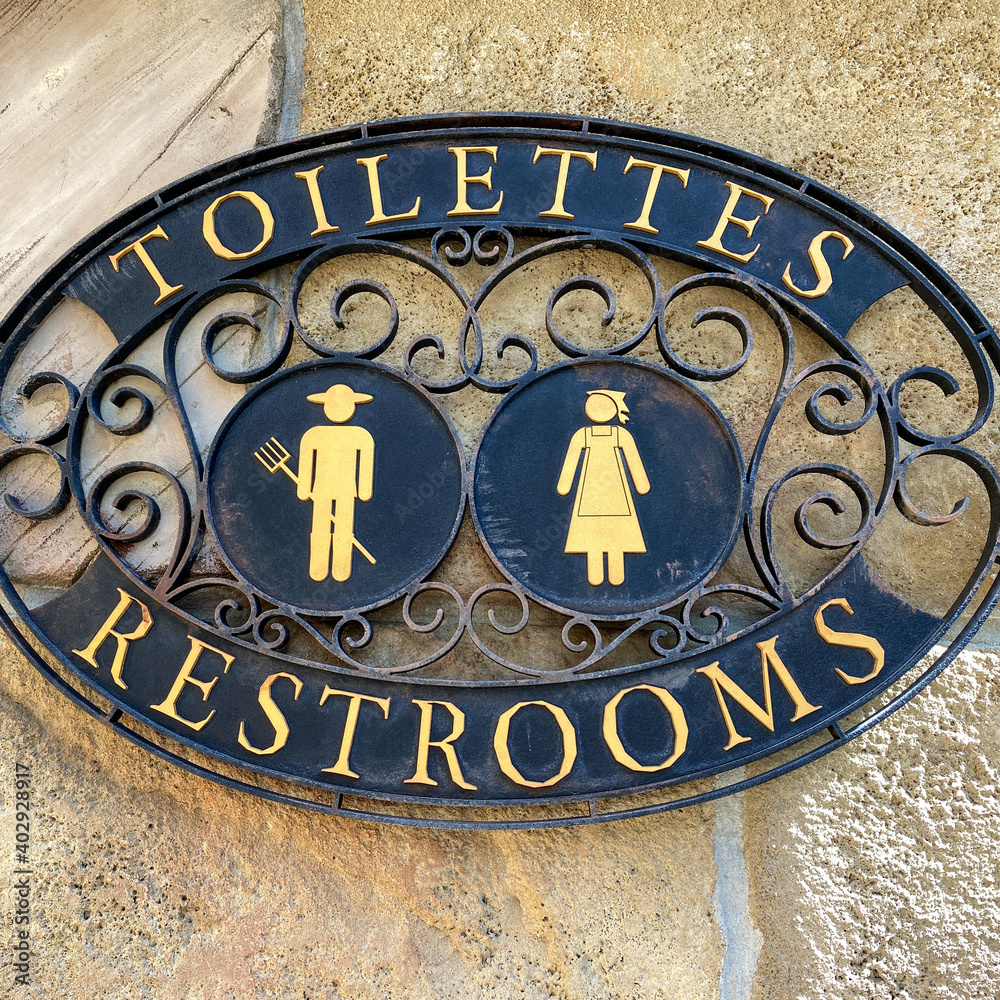 A sign signifying a restroom entrance. A sign signifying a restroom entrance.