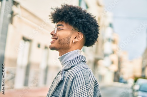 Young african american businessman smiling happy standing at the city.