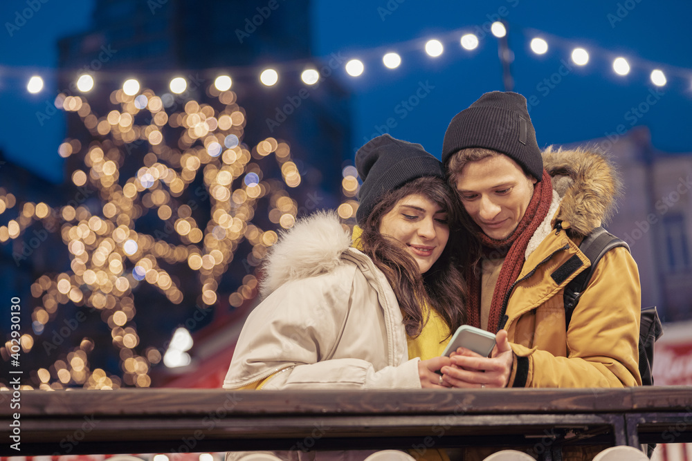 Happy cheerful and young caucasian couple are having fun while dating together outdoors in a city Happy cheerful and young caucasian couple are having fun while dating together outdoors in a city