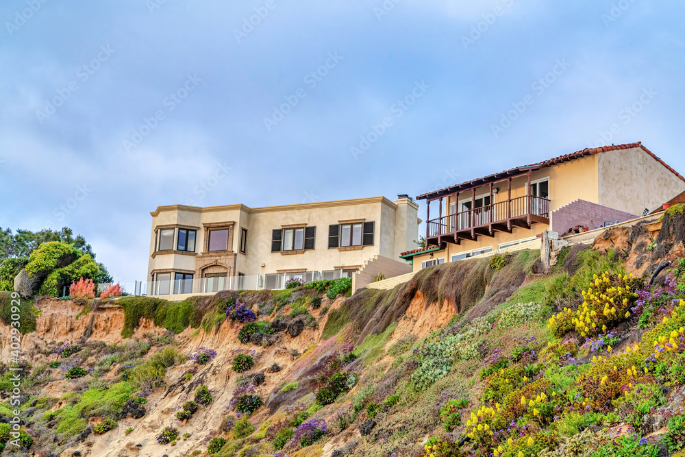 Buildings on steep land with cloudy blue sky background in San Diego California