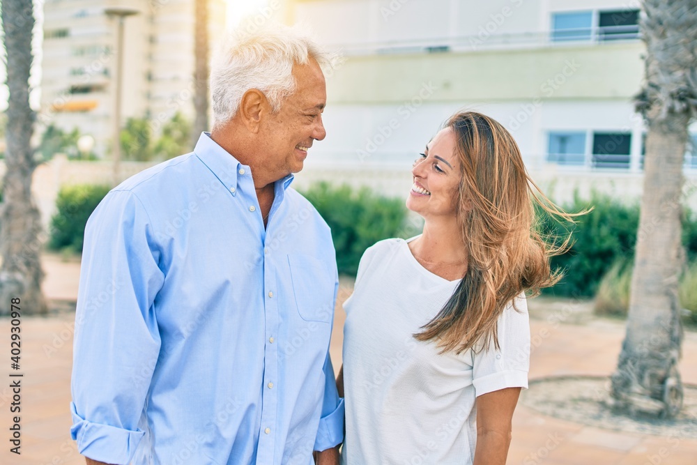 Middle age hispanic couple smiling happy standing at the promenade. Middle age hispanic couple smiling happy standing at the promenade.