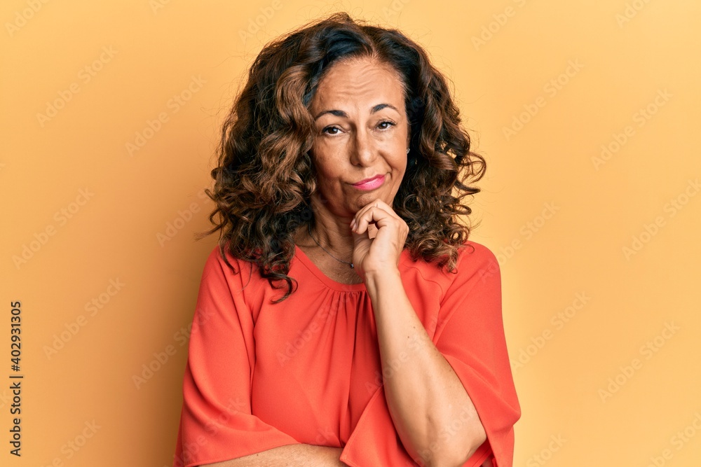 Middle age hispanic woman wearing casual clothes thinking looking tired and bored with depression problems with crossed arms. Middle age hispanic woman wearing casual clothes thinking looking tired and bored with depression problems with crossed arms.