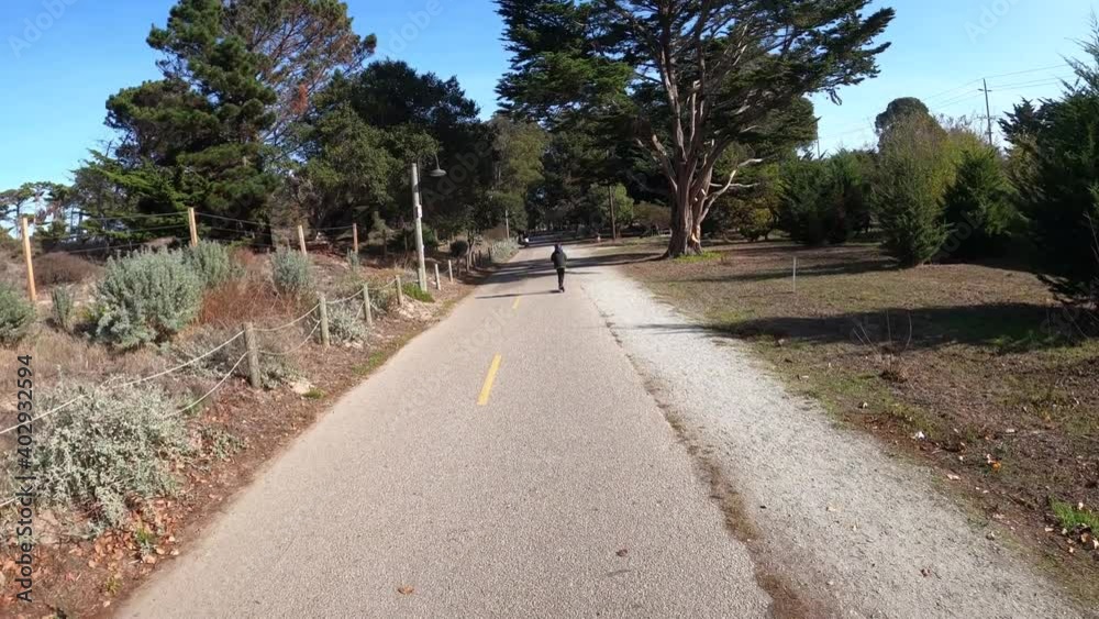 Boy riding an electric scooter on the Monterey Bay Recreational Trail in Northern California (USA). Boy riding an electric scooter on the Monterey Bay Recreational Trail in Northern California (USA).