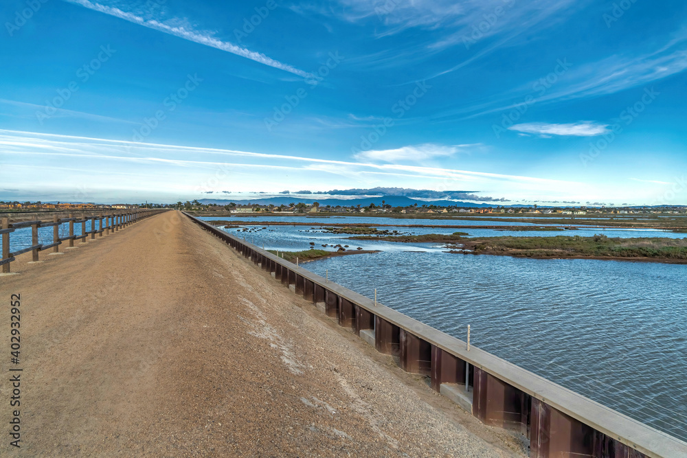 Footbridge and scenic wetlands in Bolsa Chica Nature Reserve Huntington Beach CA