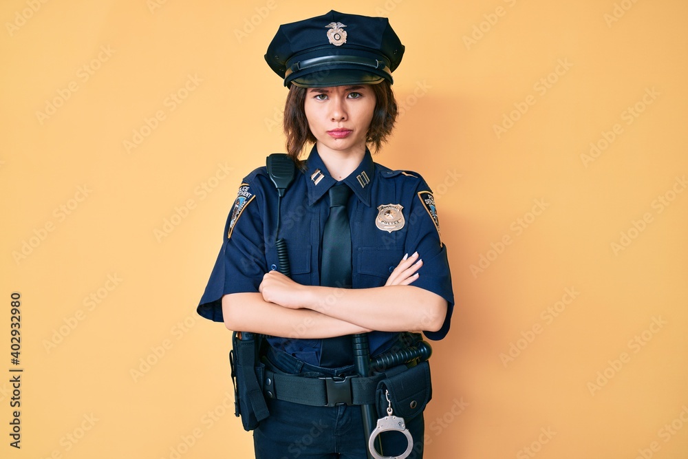 Young beautiful woman wearing police uniform skeptic and nervous, disapproving expression on face with crossed arms. negative person. Young beautiful woman wearing police uniform skeptic and nervous, disapproving expression on face with crossed arms. negative person.