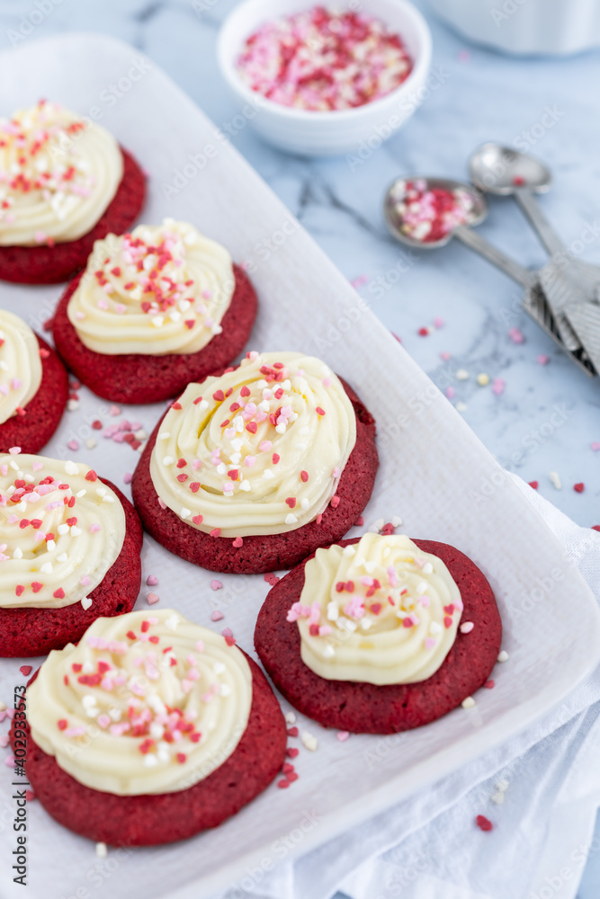 Red velvet cupcakes with white icing and heart shaped decorations