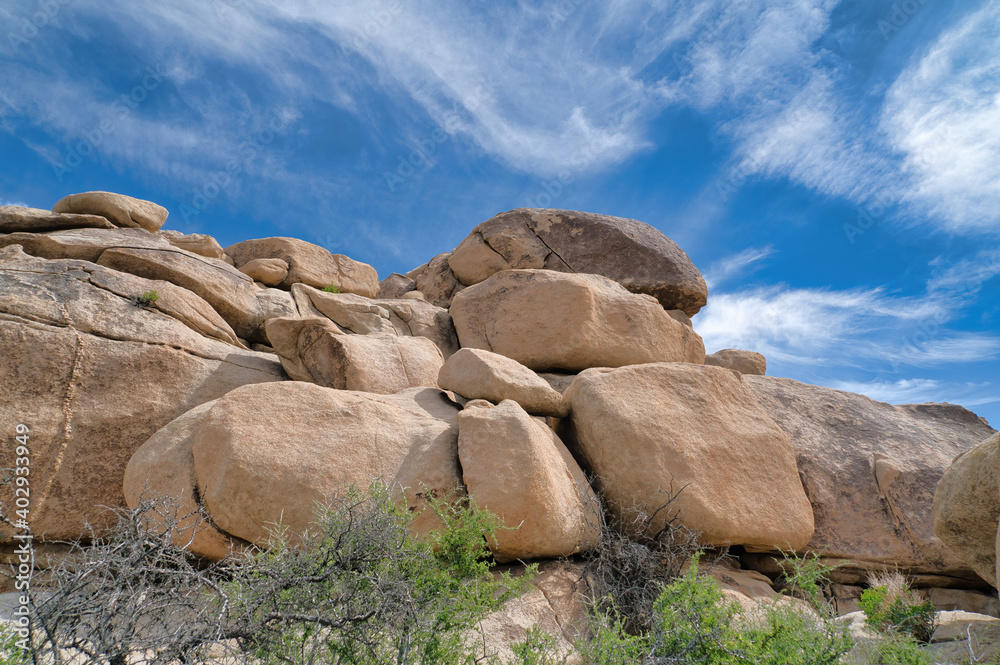 Huge rocks under blue sky and clouds at Joshua Tree National Park in California
