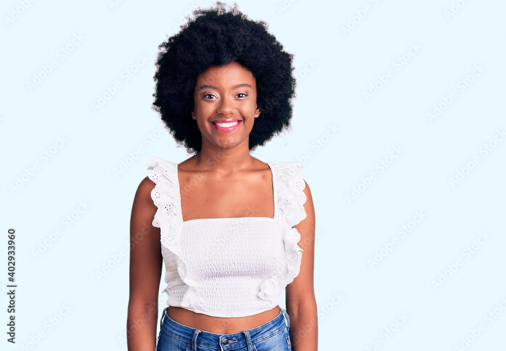 Young african american woman wearing casual clothes with a happy and cool smile on face. lucky person. Young african american woman wearing casual clothes with a happy and cool smile on face. lucky person.