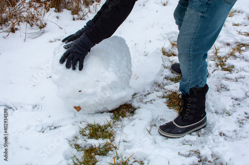 Wallpaper Mural Glove covered hands building snowballs and snowmen in the deep snow. Torontodigital.ca