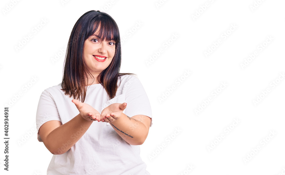 Young plus size woman wearing casual clothes smiling with hands palms together receiving or giving gesture. hold and protection Young plus size woman wearing casual clothes smiling with hands palms together receiving or giving gesture. hold and protection