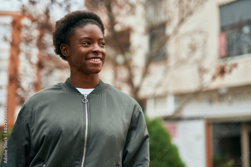 Young african american girl smiling happy standing at the city.