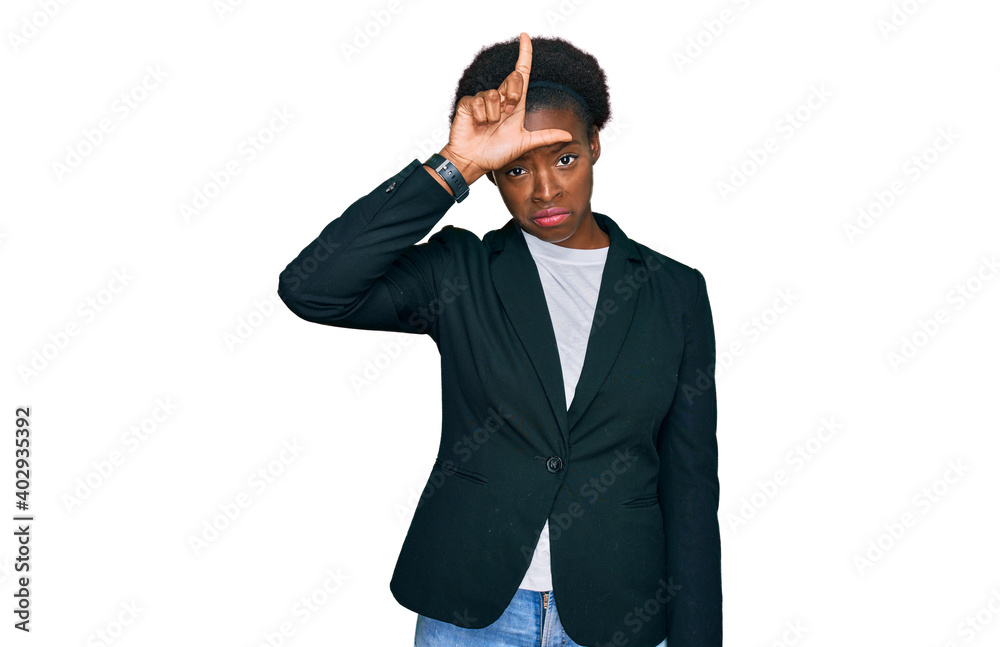 Young african american girl wearing business clothes making fun of people with fingers on forehead doing loser gesture mocking and insulting. Young african american girl wearing business clothes making fun of people with fingers on forehead doing loser gesture mocking and insulting.