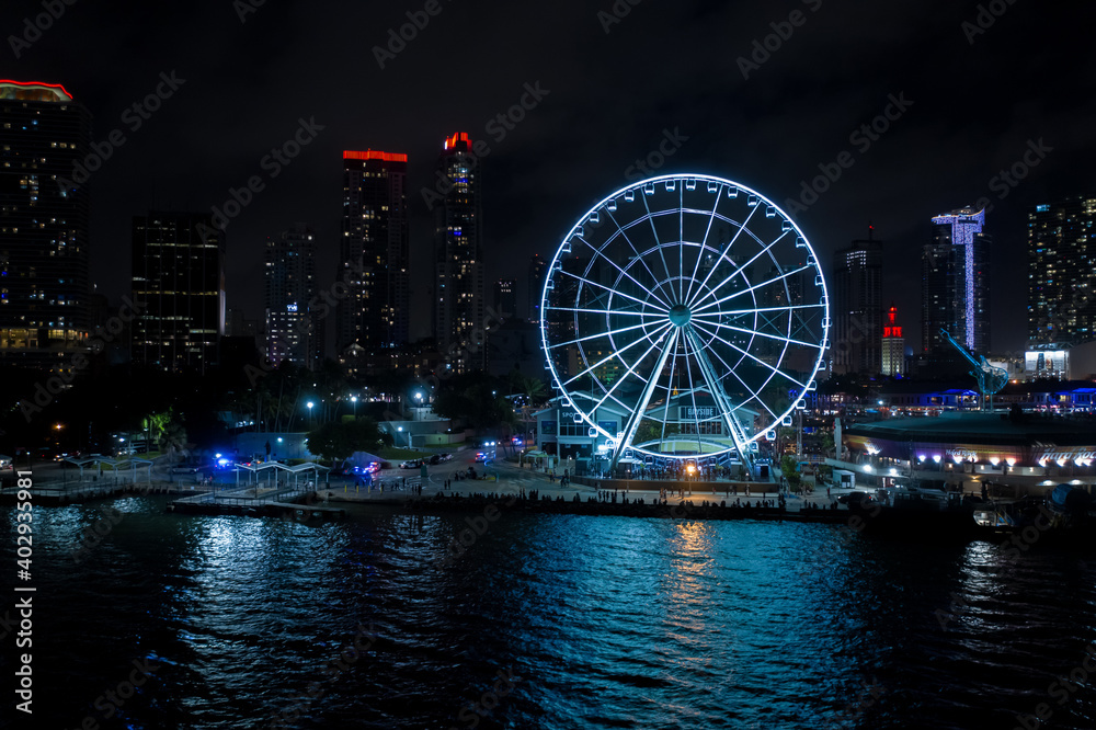 Night aerial panorama Miami Skyviews ferris wheel at Bayside Marketplace reflection in water