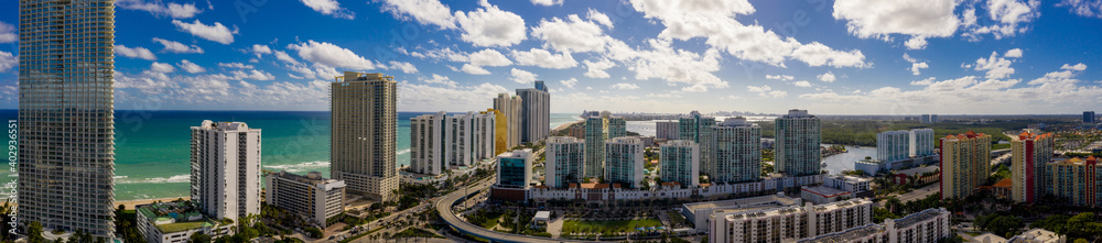 Aerial panorama Sunny Isles Beach facing south at 163rd Street highrise beachfront condominiums in photo