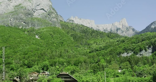 Sideshot of truck driving through motorway with alps mountains in the background in summer photo