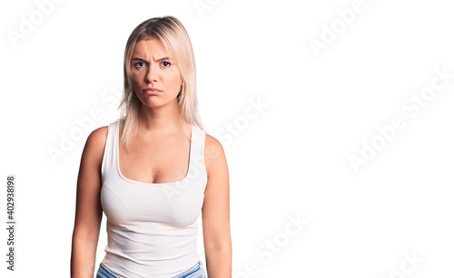 Young beautiful blonde woman wearing casual sleeveless t-shirt skeptic and nervous, frowning upset because of problem. negative person. © Krakenimages.com