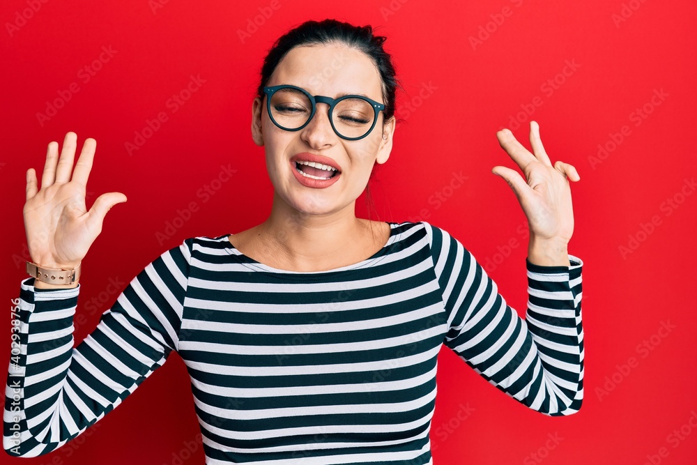 Young caucasian woman wearing casual clothes and glasses showing and pointing up with fingers number nine while smiling confident and happy. Young caucasian woman wearing casual clothes and glasses showing and pointing up with fingers number nine while smiling confident and happy.