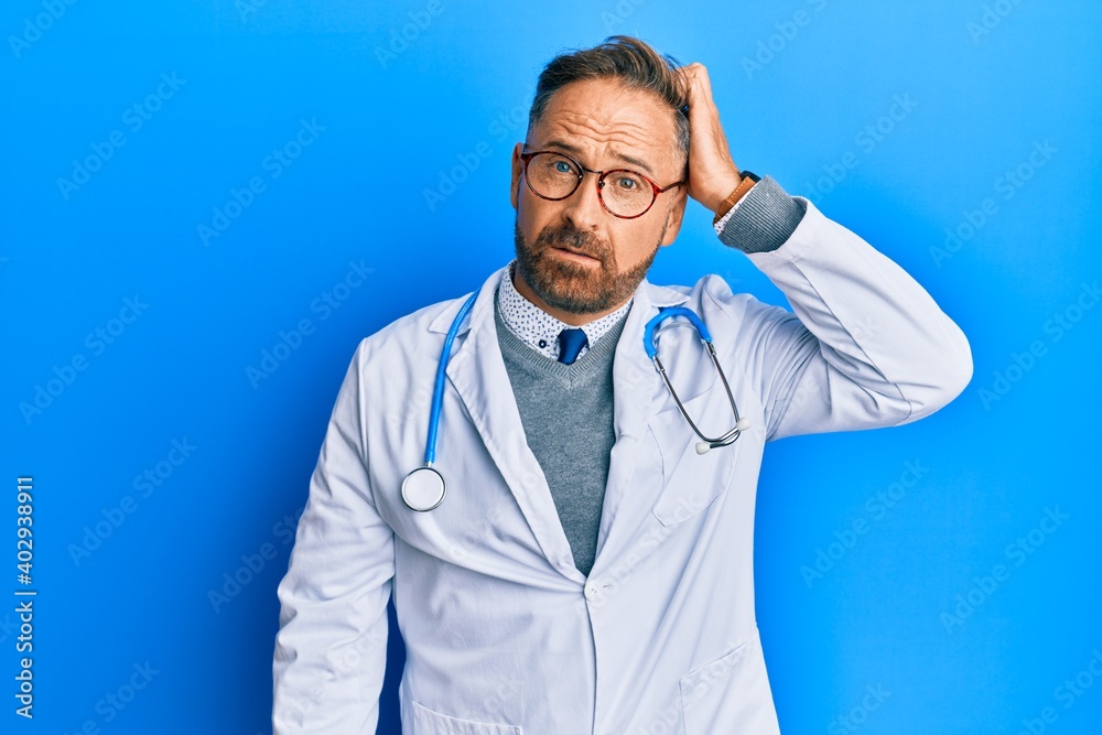 Handsome middle age man wearing doctor uniform and stethoscope confuse and wonder about question. uncertain with doubt, thinking with hand on head. pensive concept. Handsome middle age man wearing doctor uniform and stethoscope confuse and wonder about question. uncertain with doubt, thinking with hand on head. pensive concept.