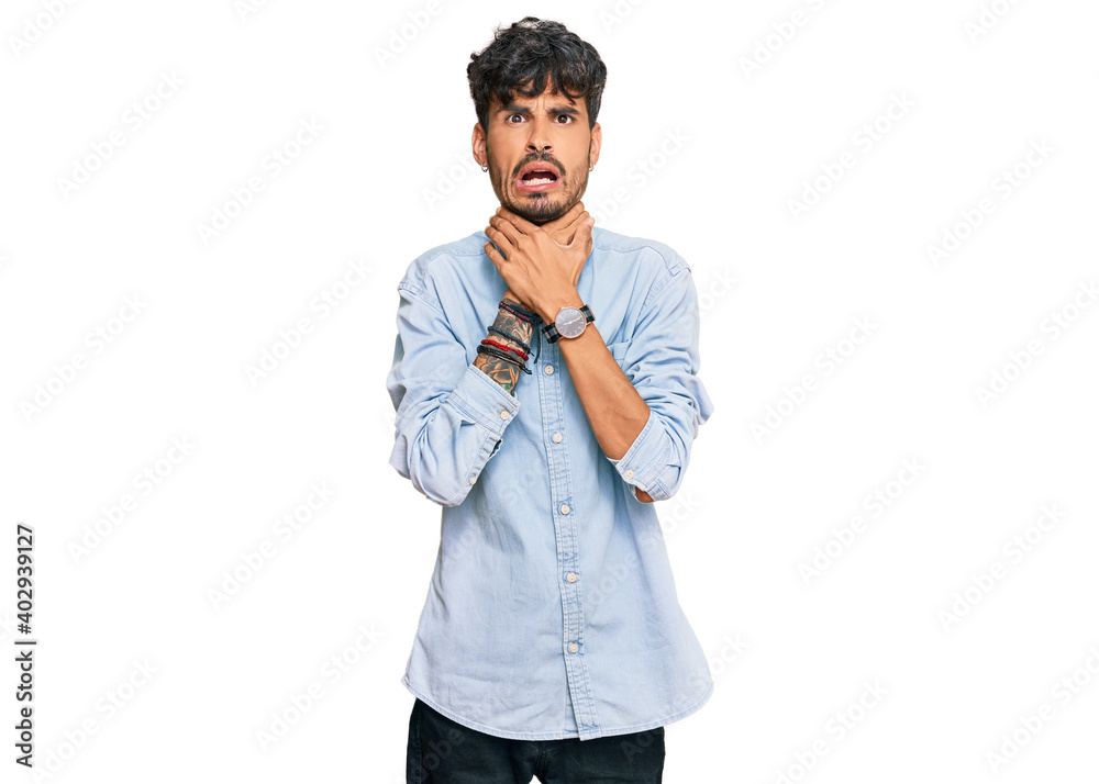 Young hispanic man wearing casual clothes shouting suffocate because painful strangle. health problem. asphyxiate and suicide concept. Young hispanic man wearing casual clothes shouting suffocate because painful strangle. health problem. asphyxiate and suicide concept.