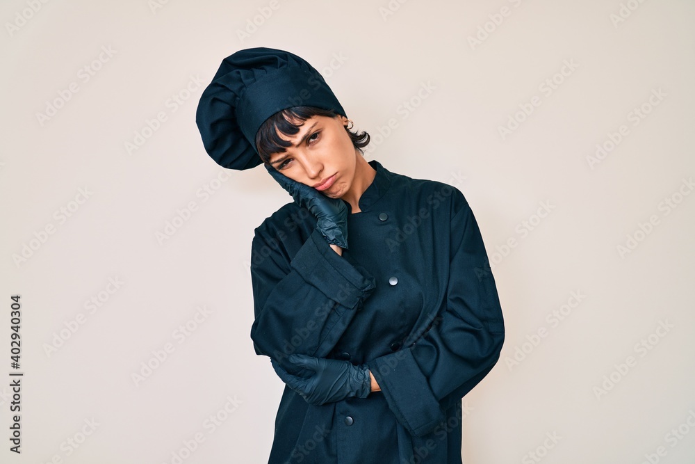 Beautiful brunettte woman wearing professional cook uniform thinking looking tired and bored with depression problems with crossed arms. Beautiful brunettte woman wearing professional cook uniform thinking looking tired and bored with depression problems with crossed arms.
