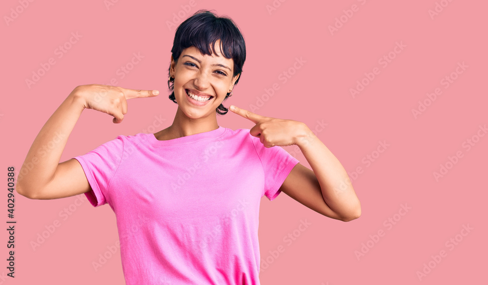 Young brunette woman with short hair wearing casual clothes smiling cheerful showing and pointing with fingers teeth and mouth. dental health concept. Young brunette woman with short hair wearing casual clothes smiling cheerful showing and pointing with fingers teeth and mouth. dental health concept.
