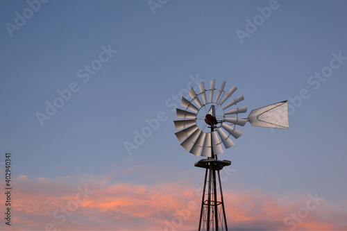 windmill on a hill at sunset