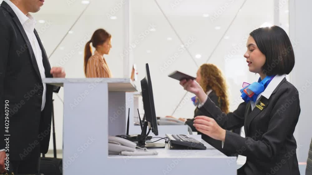 Asian businessman handing passport to airline staff at checkin counter