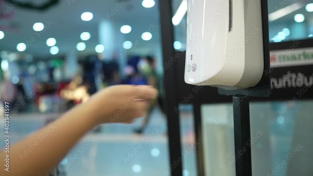 custom made wallpaper toronto digitalwoman putting hands in spray alcohol machine to clean hands before go in supermarket