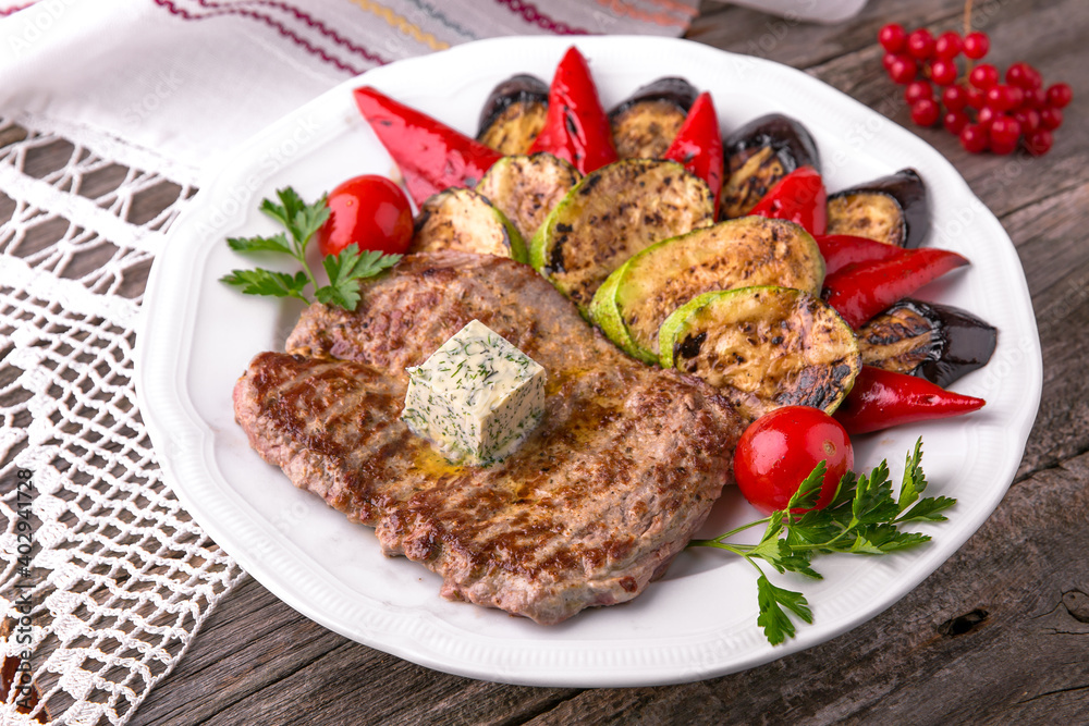 Pork steak grilled with grilled vegetables. Balkan cuisine. National cuisine. Nourishing, useful, natural. Rustic cuisine.