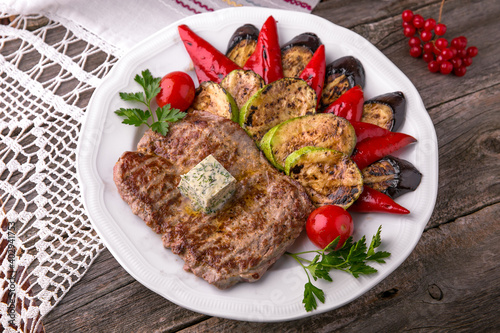 Pork steak grilled with grilled vegetables. Balkan cuisine. National cuisine. Nourishing, useful, natural. Rustic cuisine.