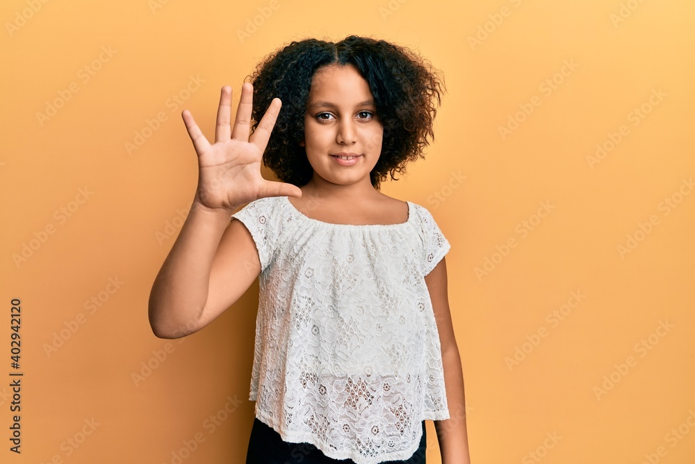 Young little girl with afro hair wearing casual clothes showing and pointing up with fingers number five while smiling confident and happy.