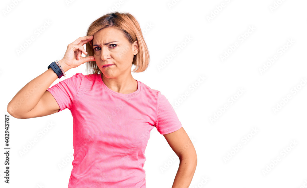 Young blonde woman wearing sportswear worried and stressed about a problem with hand on forehead, nervous and anxious for crisis Young blonde woman wearing sportswear worried and stressed about a problem with hand on forehead, nervous and anxious for crisis