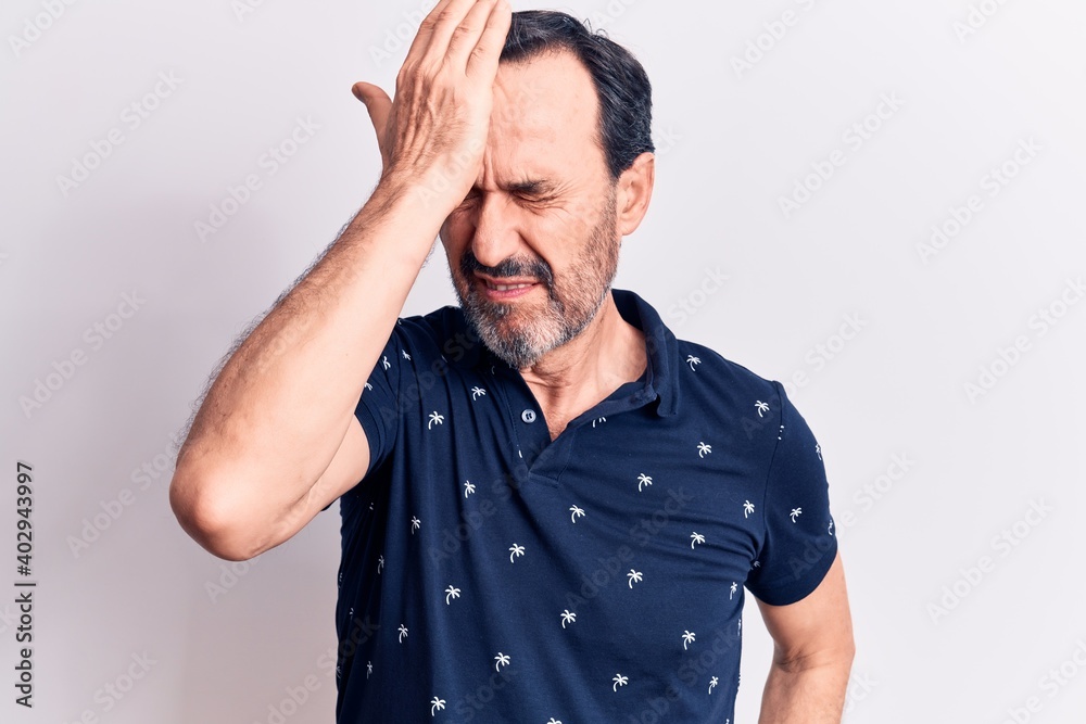 Middle age handsome man wearing casual polo standing over isolated white background surprised with hand on head for mistake, remember error. Forgot, bad memory concept. Middle age handsome man wearing casual polo standing over isolated white background surprised with hand on head for mistake, remember error. Forgot, bad memory concept.