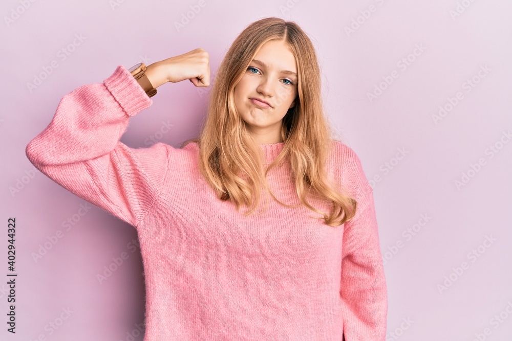 Beautiful young caucasian girl wearing casual clothes strong person showing arm muscle, confident and proud of power