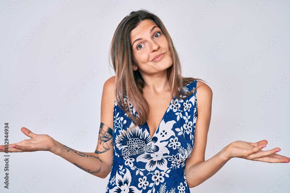 Beautiful caucasian woman wearing casual clothes clueless and confused expression with arms and hands raised. doubt concept. Beautiful caucasian woman wearing casual clothes clueless and confused expression with arms and hands raised. doubt concept.