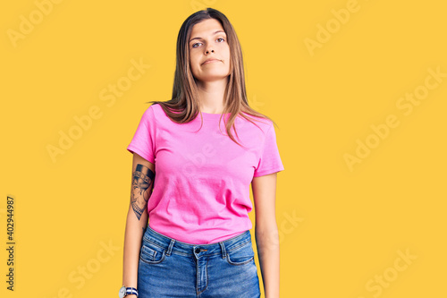 Beautiful caucasian woman wearing casual clothes looking sleepy and tired, exhausted for fatigue and hangover, lazy eyes in the morning.