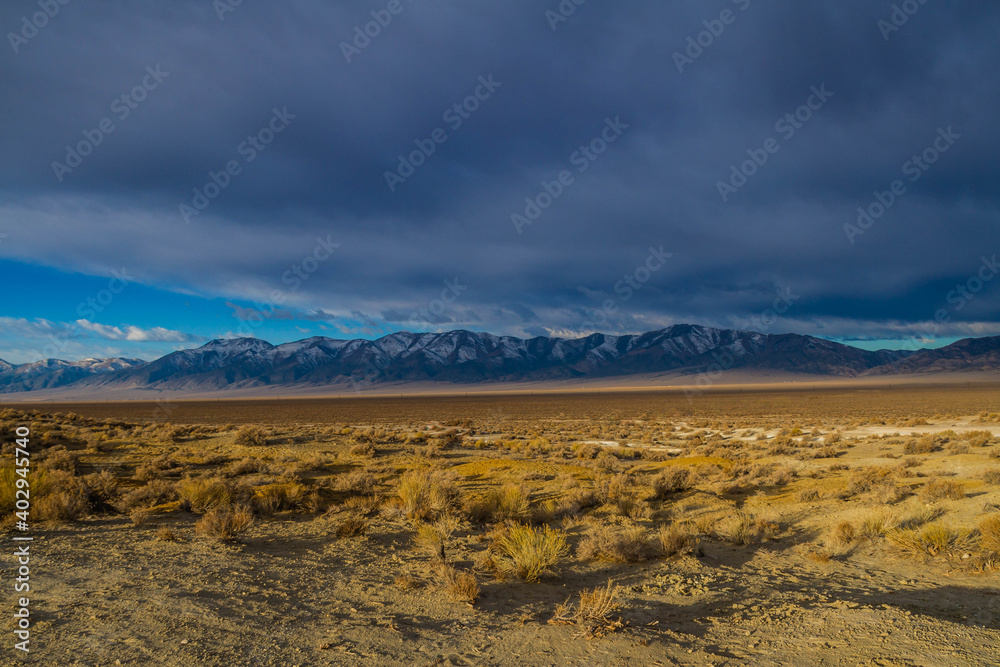 Snowcapped mountains across a valley in Nevada along highway 376. Snowcapped mountains across a valley in Nevada along highway 376.
