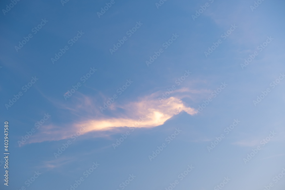 Orange clouds in the blue sky.Shapeless clouds