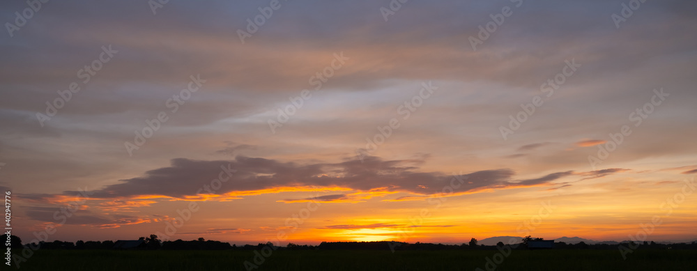 Colorful sunset and sunrise with clouds.Blue and orange color of nature.Many white clouds in the blue sky.The weather is clear today.sunset in the clouds.The sky is twilight
