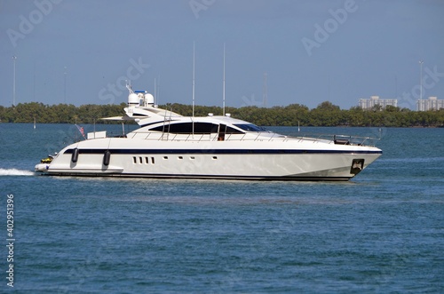 Sleek white motor yacht cruising slowly on the Florida Intra-Coastal Waterway © Wimbledon