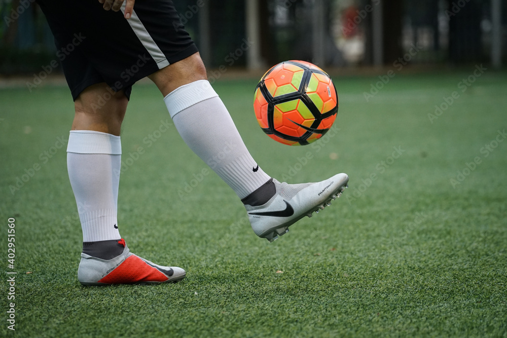 Bangkok/Thailand - August 2018: Football player is training on field with Nike  Phantom Vision Elite. This is new football boots designed for Playmaker.  Presented by Kevin De Bruyne and Coutinho. Photos